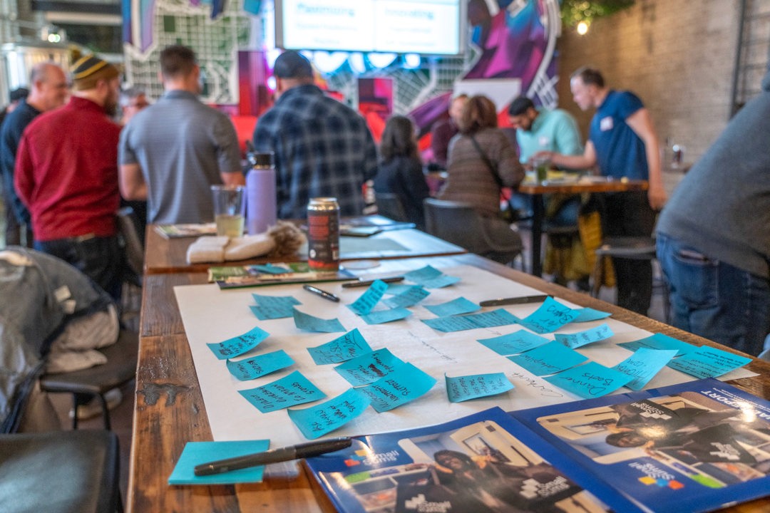 Sticky notes and challenge sheets spread across a table